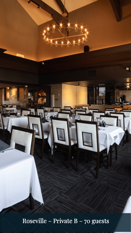 Roseville Private B, 70 guests: a dining room with a stone fireplace, a round chandelier, and tables set with white tablecloths.