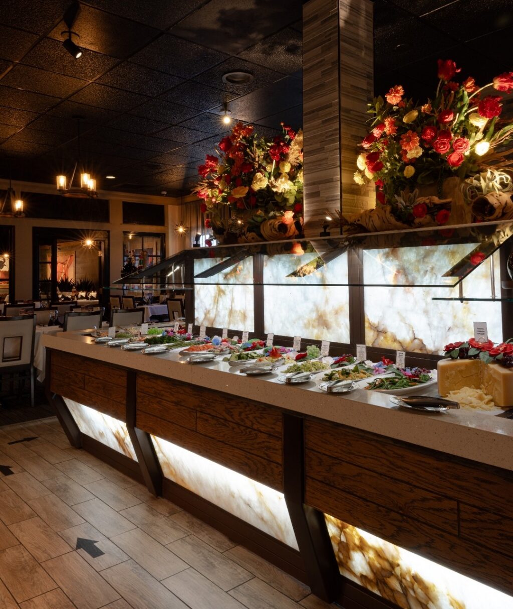 Enjoy our unlimited two-course menu that starts with a gourmet salad bar with over 40 items to choose from, plus our 18 unlimited selections from the grill. 🥗 🥦 🥕 

For a lighter choice, you can choose to stay on the first course for the whole meal and enjoy unlimited trips to our gourmet salad bar; which features cured meats, smoked salmon, candied bacon, local and imported cheeses, gourmet salads, and fresh vegetables.

This option includes the cheese bread appetizer and side dishes on our menu.

Book your table now!